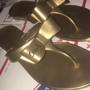 Pretty gold bow Coach jelly sandals/flip flops